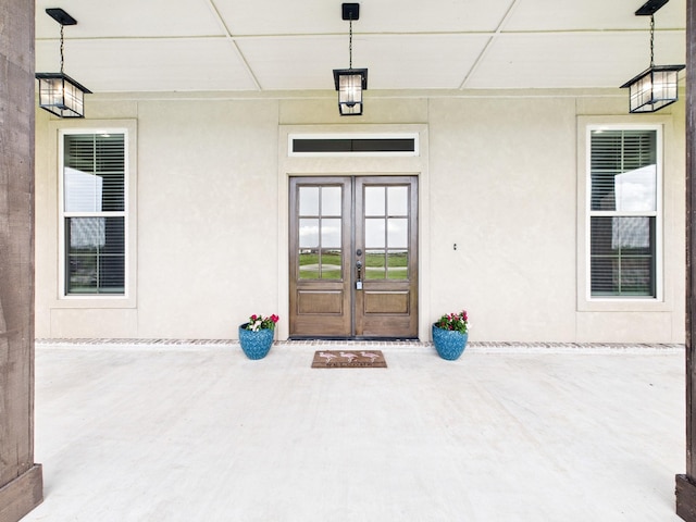 2711 Oakwood Shores Dr, Richwood, TX 77515 - entrance to property with french doors, a patio area, and stucco siding