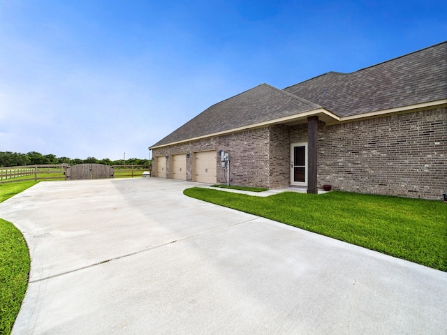 2711 Oakwood Shores Dr, Richwood, TX 77515 - view of side of home with concrete driveway, roof with shingles, and brick siding