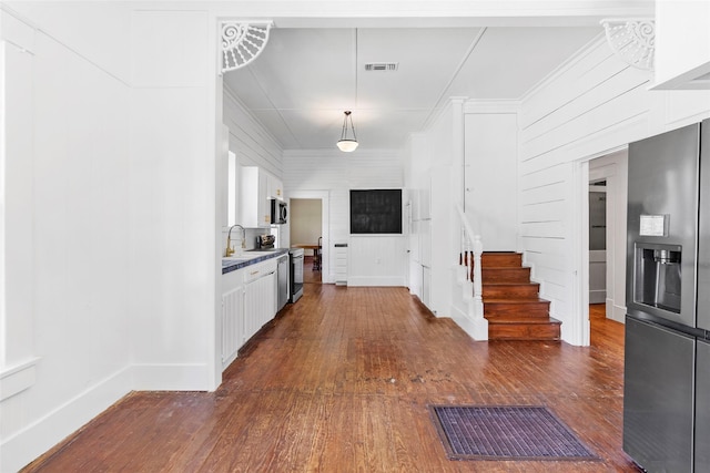 38 Darrell White Rd, Huntsville, TX 77340 - kitchen with stainless steel fridge with ice dispenser, dark wood-style flooring, white cabinetry, and decorative light fixtures