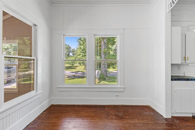 38 Darrell White Rd, Huntsville, TX 77340 - unfurnished dining area featuring radiator heating unit and dark wood-style flooring