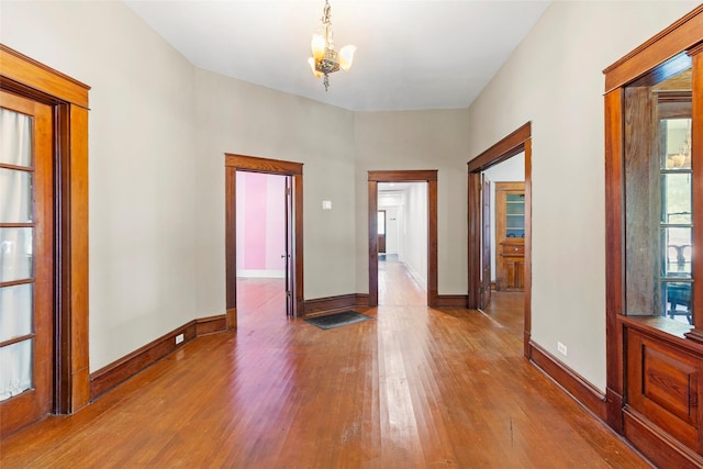 38 Darrell White Rd, Huntsville, TX 77340 - spare room featuring wood finished floors and a chandelier