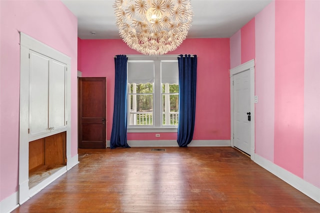 38 Darrell White Rd, Huntsville, TX 77340 - spare room featuring a chandelier and hardwood / wood-style floors