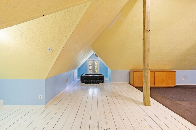 38 Darrell White Rd, Huntsville, TX 77340 - bonus room featuring a textured ceiling, vaulted ceiling, and hardwood / wood-style floors