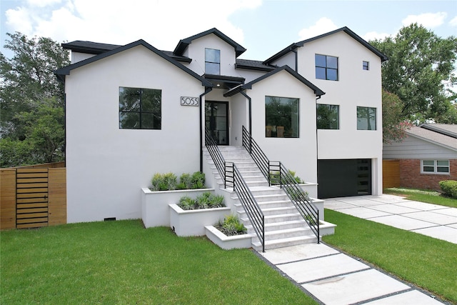5055 Yarwell Dr, Houston, TX 77096 - view of front of property featuring stucco siding, an attached garage, and concrete driveway