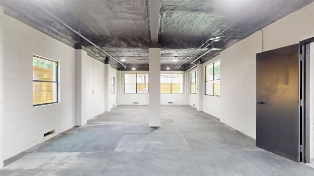 5055 Yarwell Dr, Houston, TX 77096 - hallway with concrete floors, concrete block wall, and plenty of natural light