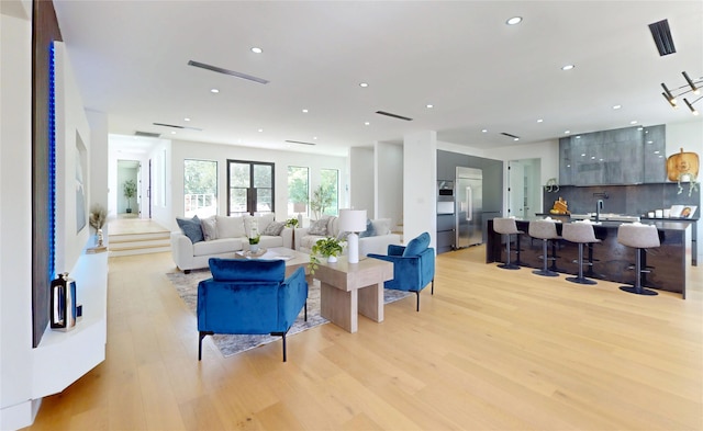 5055 Yarwell Dr, Houston, TX 77096 - living area featuring light wood-style flooring and recessed lighting
