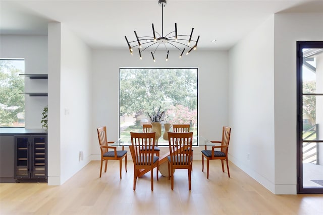 5055 Yarwell Dr, Houston, TX 77096 - dining space featuring wine cooler, wood finished floors, and a chandelier
