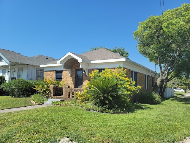 2301 45th St, Galveston, TX 77551 - ranch-style house featuring brick siding and a front yard