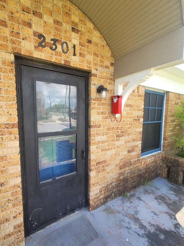2301 45th St, Galveston, TX 77551 - doorway to property with brick siding