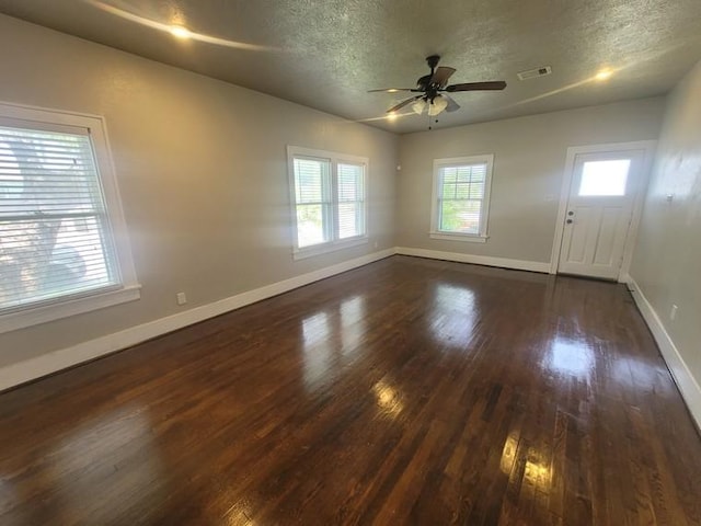 2301 45th St, Galveston, TX 77551 - spare room featuring a textured ceiling, dark wood finished floors, and ceiling fan
