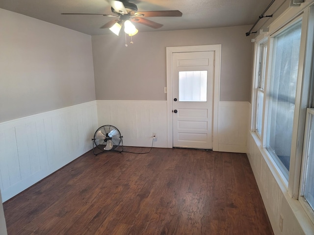 2301 45th St, Galveston, TX 77551 - empty room with wainscoting, a ceiling fan, and wood finished floors