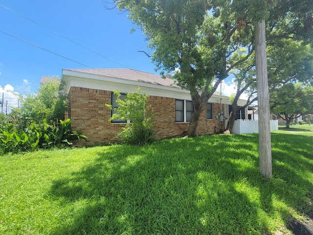 2301 45th St, Galveston, TX 77551 - view of home's exterior featuring a yard and brick siding