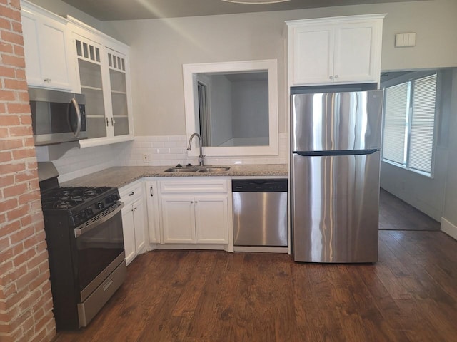 2301 45th St, Galveston, TX 77551 - kitchen featuring stainless steel appliances, light stone counters, white cabinets, and decorative backsplash