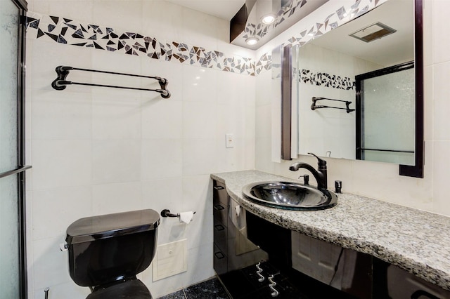 2001 Holcombe Blvd Unit 206, Houston, TX 77030 - full bathroom with tile walls, a shower stall, and vanity
