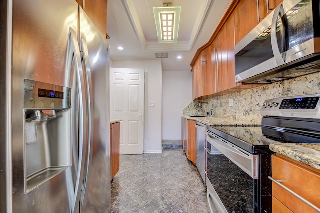 2001 Holcombe Blvd Unit 206, Houston, TX 77030 - kitchen featuring appliances with stainless steel finishes, brown cabinets, recessed lighting, tasteful backsplash, and a raised ceiling