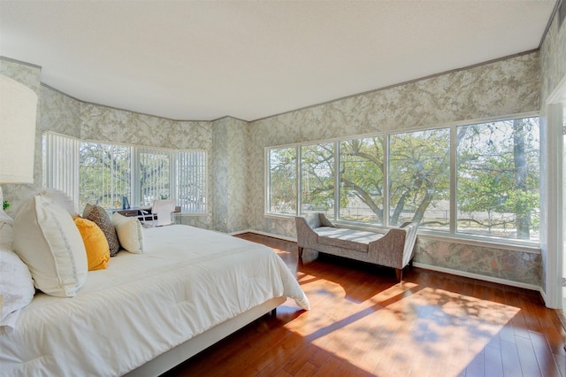 2001 Holcombe Blvd Unit 206, Houston, TX 77030 - bedroom with hardwood / wood-style flooring and wallpapered walls