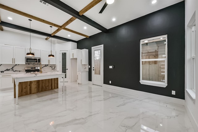 613 Melbourne St, Houston, TX 77022 - kitchen featuring stainless steel appliances, beam ceiling, white cabinets, recessed lighting, and decorative light fixtures