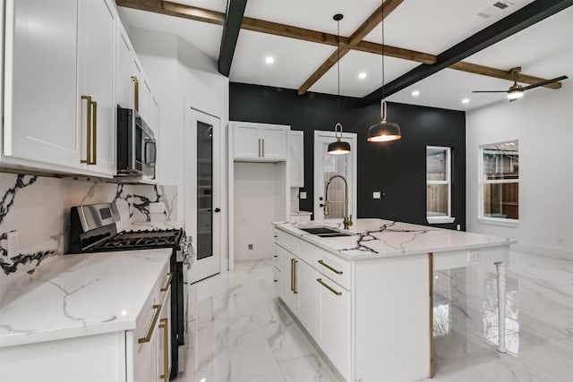 613 Melbourne St, Houston, TX 77022 - kitchen featuring appliances with stainless steel finishes, recessed lighting, beam ceiling, white cabinets, and an island with sink