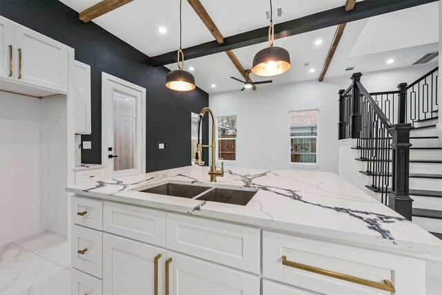 613 Melbourne St, Houston, TX 77022 - kitchen featuring beam ceiling, white cabinets, pendant lighting, recessed lighting, and light stone counters