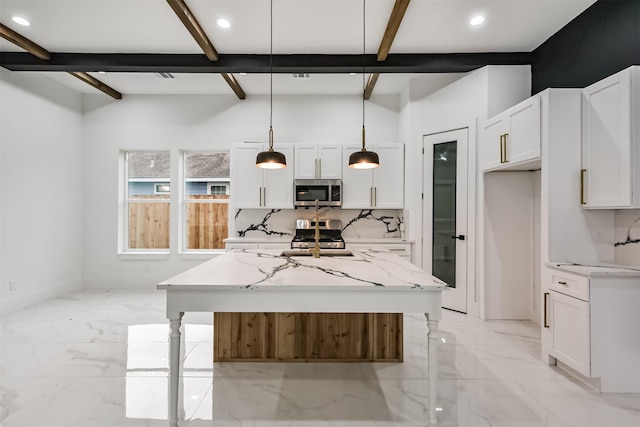 613 Melbourne St, Houston, TX 77022 - kitchen with stainless steel appliances, beam ceiling, white cabinets, pendant lighting, and a kitchen island