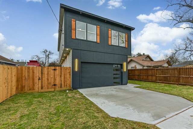 613 Melbourne St, Houston, TX 77022 - view of front of house with a garage, concrete driveway, and board and batten siding