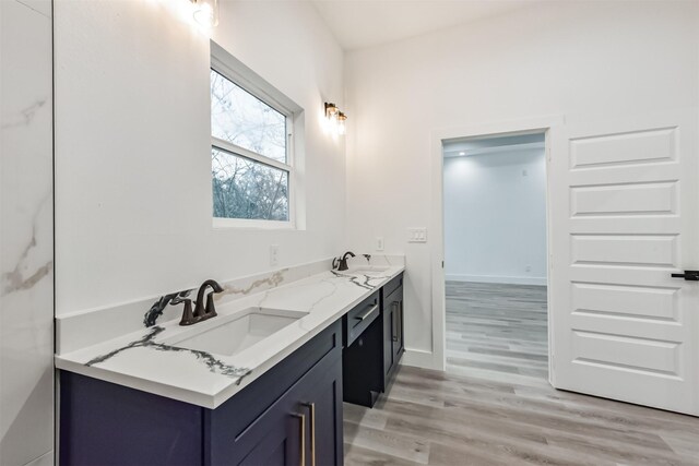 613 Melbourne St, Houston, TX 77022 - bathroom featuring double vanity and wood finished floors