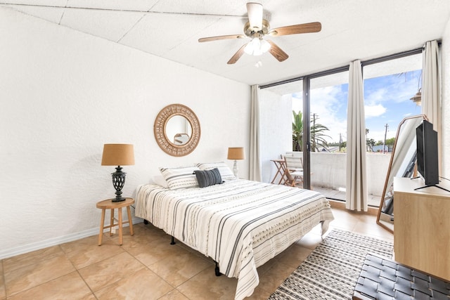 14401 Commodores Dr Unit 104, Corpus Christi, TX 78418 - bedroom featuring access to exterior, light tile patterned flooring, a textured wall, a ceiling fan, and floor to ceiling windows