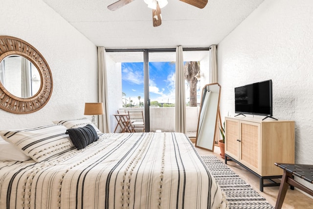 14401 Commodores Dr Unit 104, Corpus Christi, TX 78418 - bedroom with a textured wall, floor to ceiling windows, access to exterior, and a ceiling fan