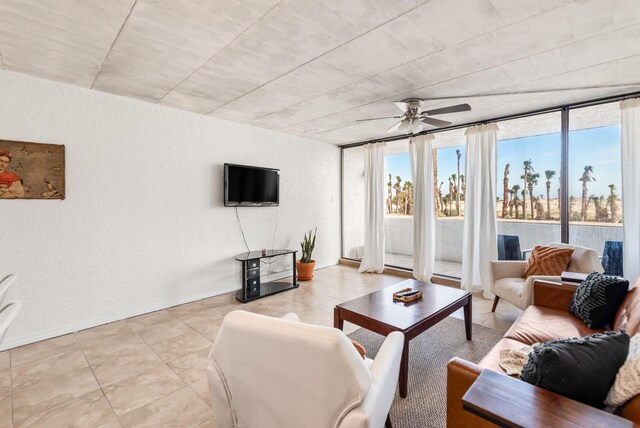 14401 Commodores Dr Unit 104, Corpus Christi, TX 78418 - living room featuring a textured wall, a ceiling fan, and light tile patterned floors