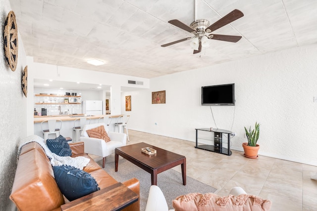 14401 Commodores Dr Unit 104, Corpus Christi, TX 78418 - living room featuring ceiling fan, a textured wall, and light tile patterned flooring