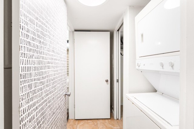 14401 Commodores Dr Unit 104, Corpus Christi, TX 78418 - laundry room featuring stacked washer / drying machine and light tile patterned floors