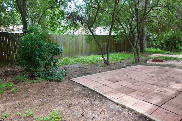 12227 Gun Oak Pl, The Woodlands, TX 77380 - fenced backyard featuring a patio area and an outdoor fire pit