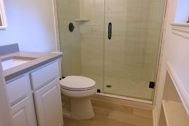 12227 Gun Oak Pl, The Woodlands, TX 77380 - bathroom with vanity, a stall shower, and wood finished floors