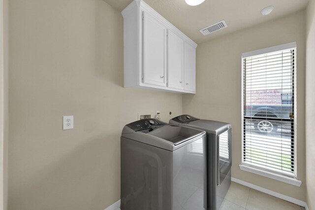 3519 El James Dr, Spring, TX 77388 - laundry room featuring washer and dryer, cabinet space, healthy amount of natural light, and light tile patterned floors