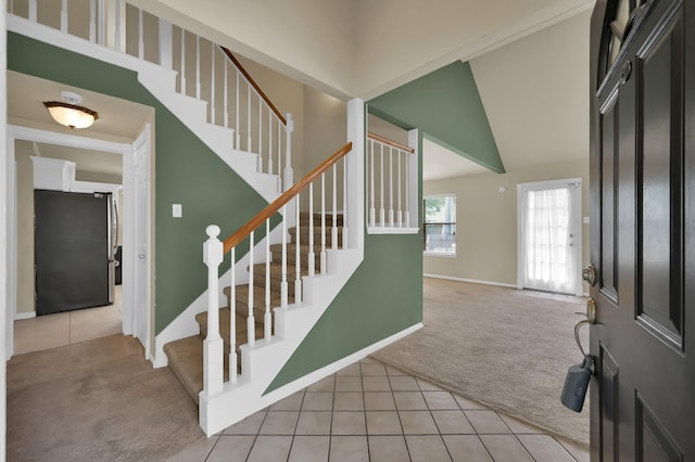 3519 El James Dr, Spring, TX 77388 - carpeted entrance foyer with tile patterned floors, stairway, and vaulted ceiling