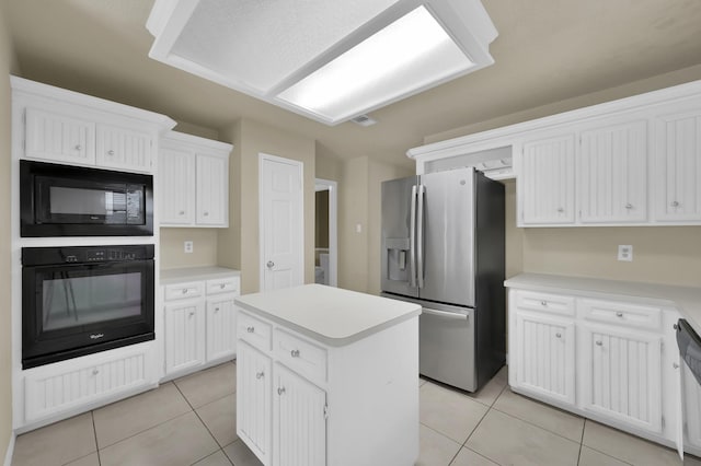 3519 El James Dr, Spring, TX 77388 - kitchen featuring black appliances, light tile patterned flooring, a kitchen island, white cabinetry, and light countertops