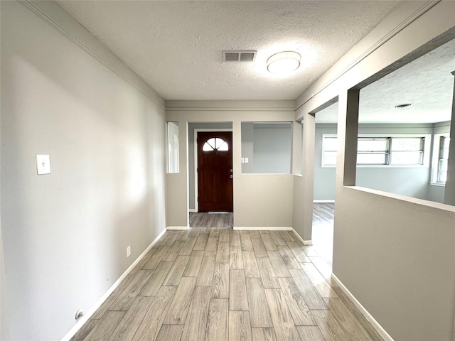 7905 Turquoise Ln, Houston, TX 77055 - foyer with a textured ceiling and light wood-type flooring