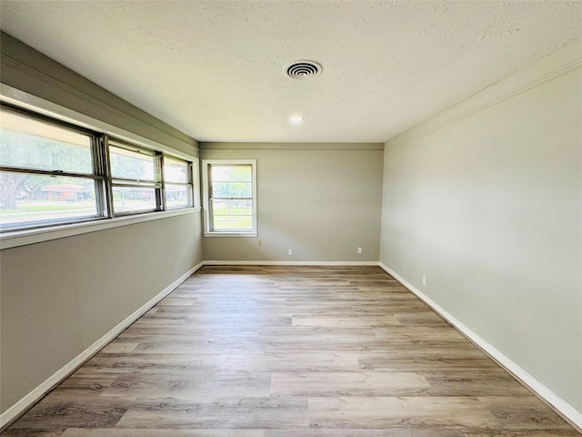 7905 Turquoise Ln, Houston, TX 77055 - unfurnished room featuring wood finished floors and a textured ceiling