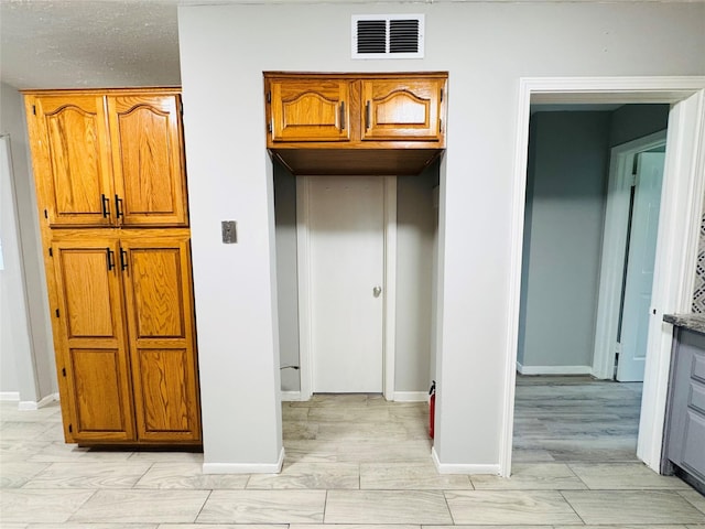 7905 Turquoise Ln, Houston, TX 77055 - kitchen featuring brown cabinetry and baseboards