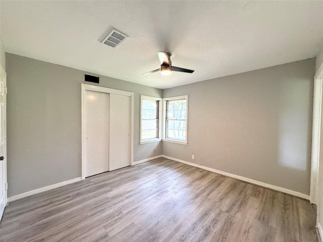 7905 Turquoise Ln, Houston, TX 77055 - unfurnished bedroom featuring wood finished floors, a closet, and a ceiling fan