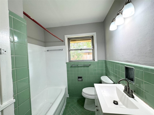 7905 Turquoise Ln, Houston, TX 77055 - full bathroom with tile patterned floors, tile walls, shower / tub combination, vanity, and a wainscoted wall