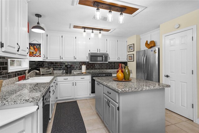 80 Indian Hbr, Trinity, TX 75862 - kitchen with stainless steel appliances, light tile patterned floors, white cabinets, and decorative backsplash