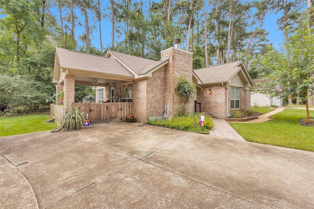 80 Indian Hbr, Trinity, TX 75862 - view of front facade with brick siding, a gate, a shingled roof, and a chimney