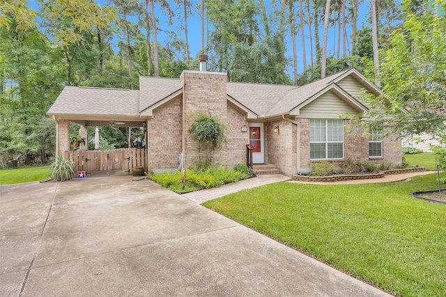 80 Indian Hbr, Trinity, TX 75862 - mid-century home with brick siding, a front lawn, a gate, and roof with shingles