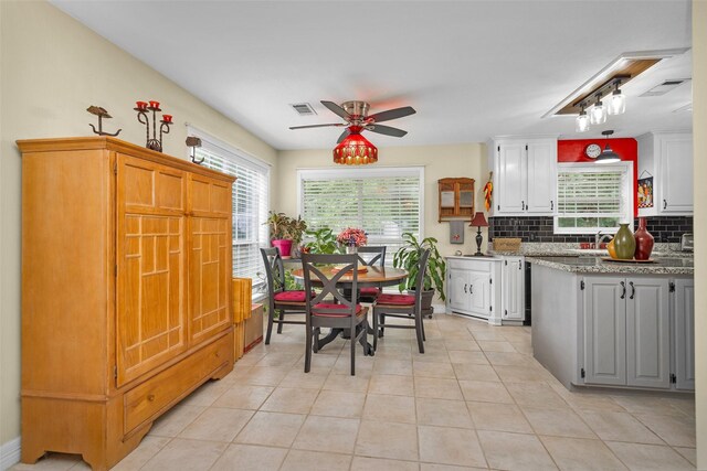 80 Indian Hbr, Trinity, TX 75862 - kitchen with healthy amount of natural light, ceiling fan, decorative backsplash, and white cabinetry