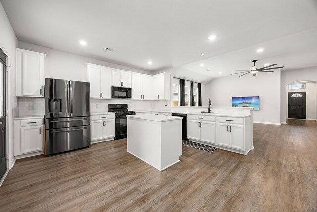11323 Cora Ln, Willis, TX 77318 - kitchen featuring black appliances, a peninsula, light countertops, white cabinetry, and wood finished floors