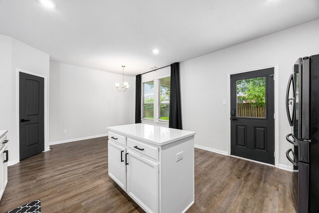 11323 Cora Ln, Willis, TX 77318 - kitchen featuring freestanding refrigerator, a chandelier, healthy amount of natural light, dark wood finished floors, and recessed lighting