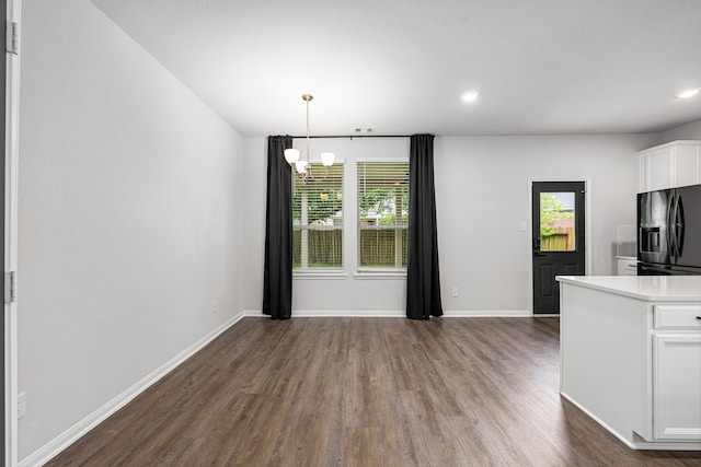 11323 Cora Ln, Willis, TX 77318 - unfurnished dining area with healthy amount of natural light, dark wood-style floors, a chandelier, and recessed lighting