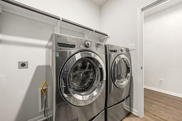 11323 Cora Ln, Willis, TX 77318 - washroom featuring light wood-style flooring and separate washer and dryer