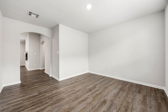 11323 Cora Ln, Willis, TX 77318 - spare room featuring arched walkways, dark wood-type flooring, and recessed lighting